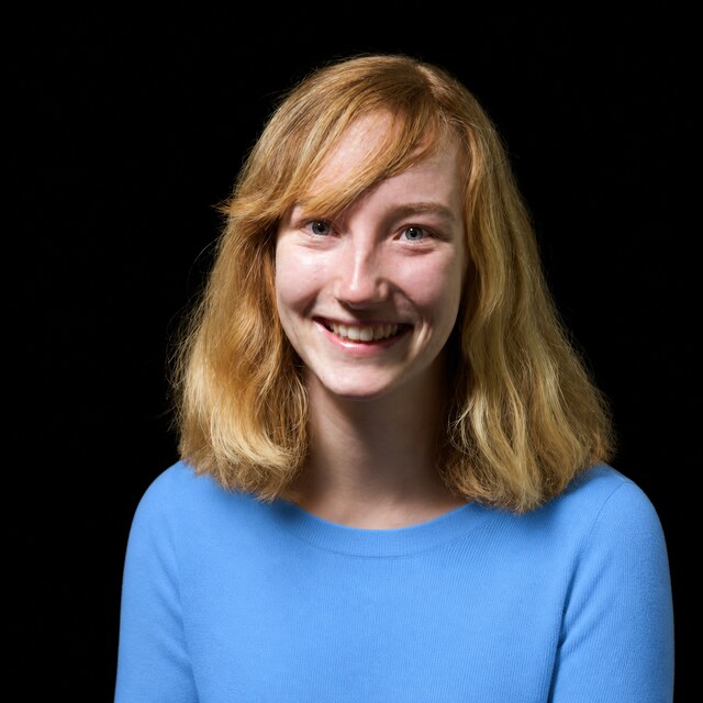 AI-generated portrait of Beth Barnes wearing a DoomBench-blue top against a black background.