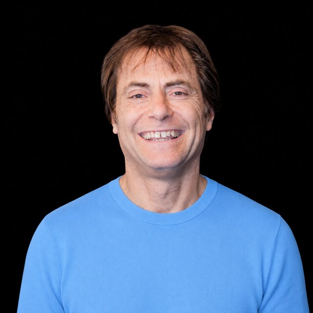 AI-generated portrait of Max Tegmark wearing a DoomBench-blue top against a black background.